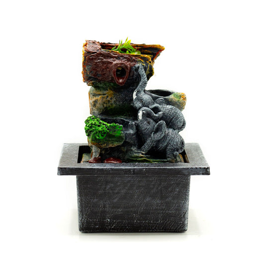 Decorative aquarium rock formation with plants on a white background